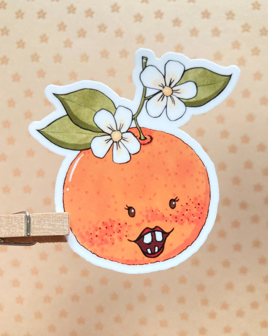 sticker d'une clémentine illustrée avec un visage